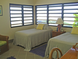 St John USVI Vacation Rental Soft Winds third bedroom with twin beds and native stonework